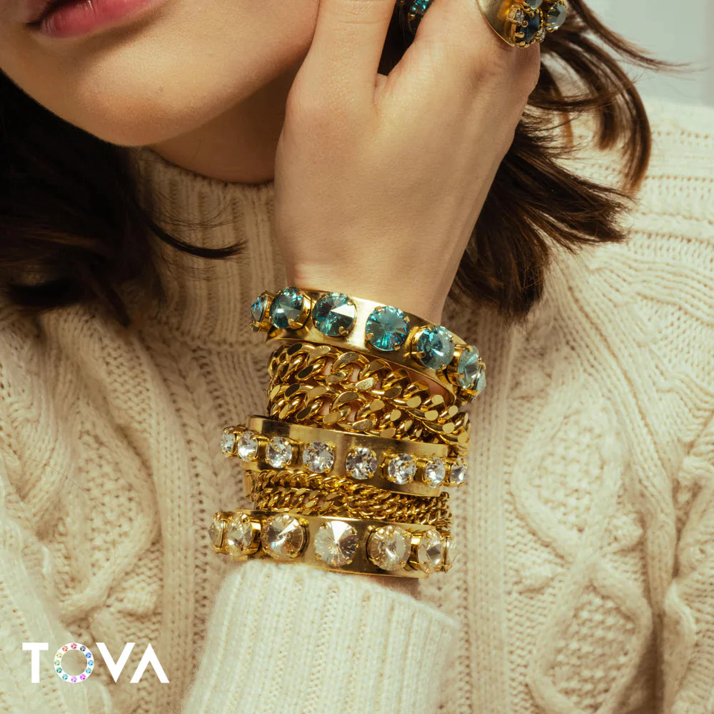 A woman wearing TOVA Jewelry brand accessories, available at shopRISE